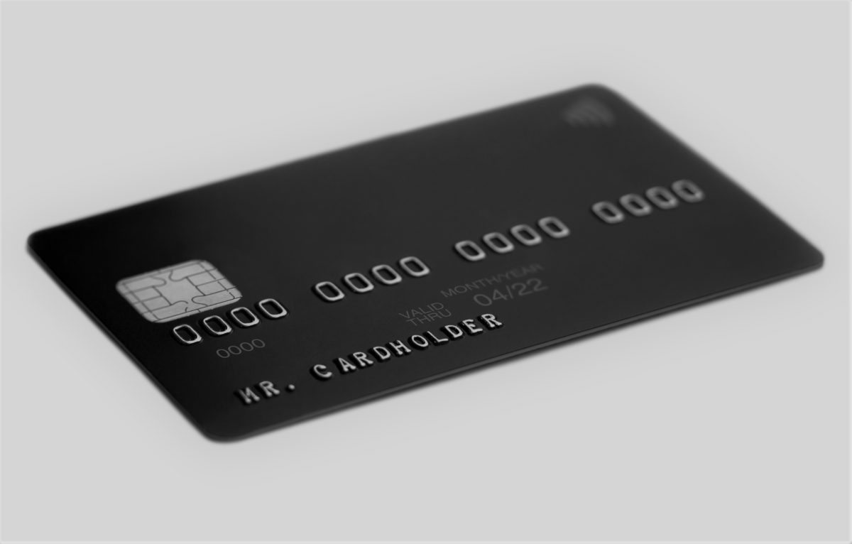 Black universal bank card on white background, cardholder name ...